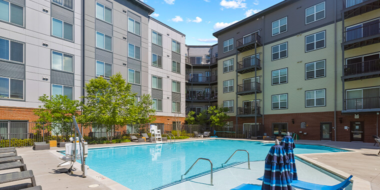 Outdoor look at Rivergate apartment and its pool